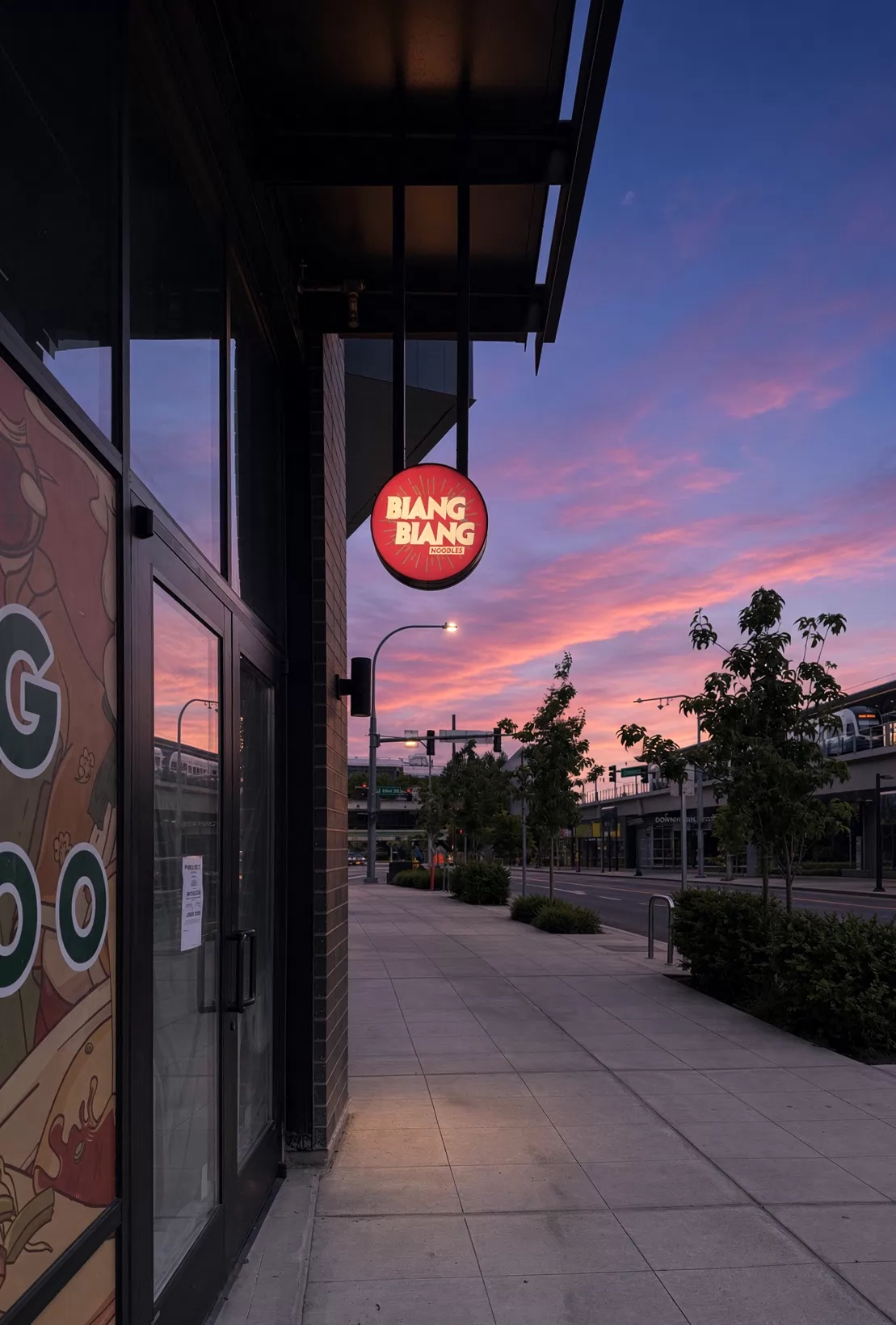 Biang Biang Noodles round projecting blade sign at sunset