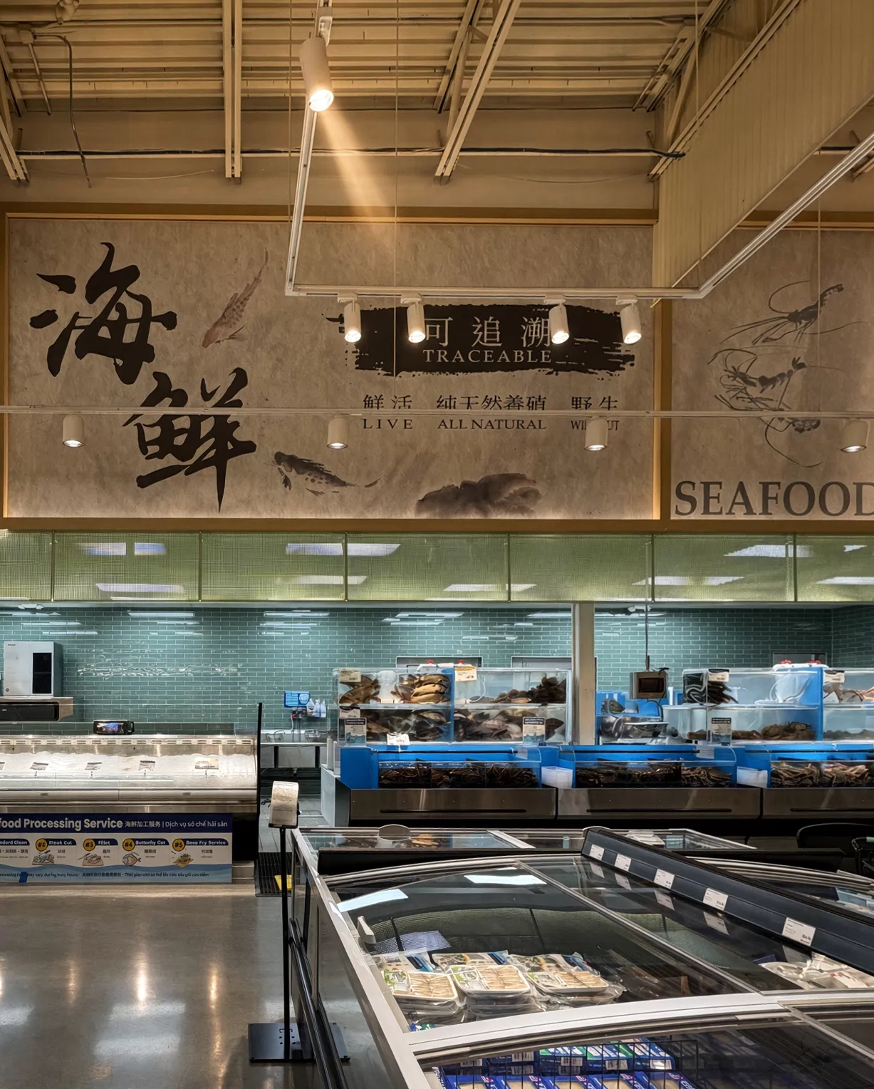 Dimensional lettering and wall graphics above a market seafood counter