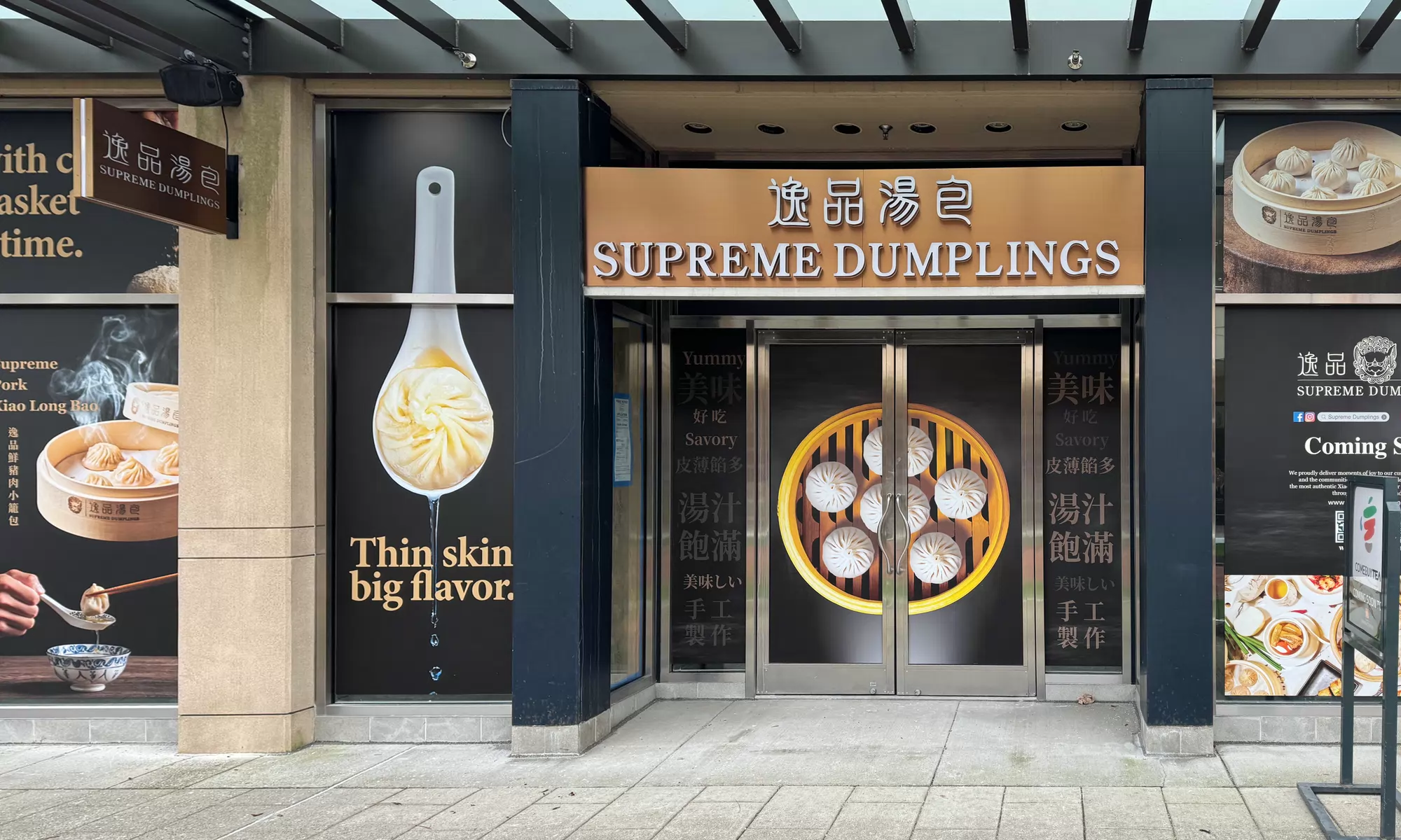 Large printed food graphics across the Supreme Dumplings storefront windows